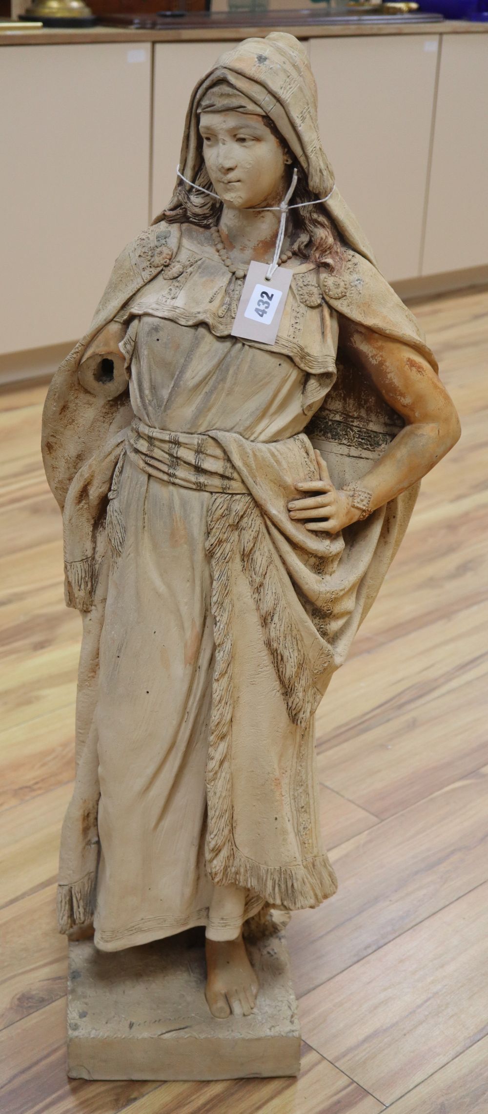 A terracotta figure of a Arabian lady, signed, height 97cm